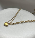 Entdecke die wunderschöne Mia Halskette aus Edelstahl – unser Bestseller! Diese Kette ist mit einem eleganten Herzanhänger versehen, der Deine feminine Ausstrahlung unterstreicht. Besonders reizvoll wirkt der kleine Herzanhänger am Ende der Kette, der perfekt zur Geltung kommt, wenn Du ein V-Ausschnitt-Oberteil trägst.
