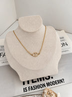 Dolce Halskette in Gold mit ovalem Zirkonia-Glied auf heller Schmuckbüste