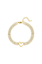 Glamouröses Lolita Armband aus 14k vergoldetem Edelstahl mit drei Reihen Zirkonia-Steinen und einem zentralen Herz-Anhänger.